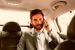 Casual business man on mobile phone in rear of the car