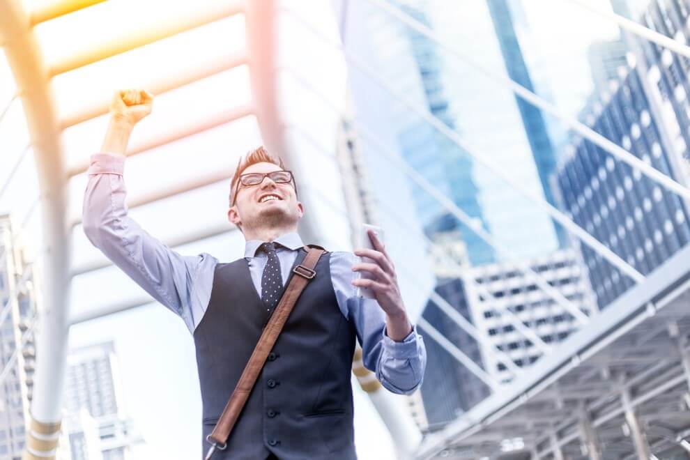 Successful businessman with arms up