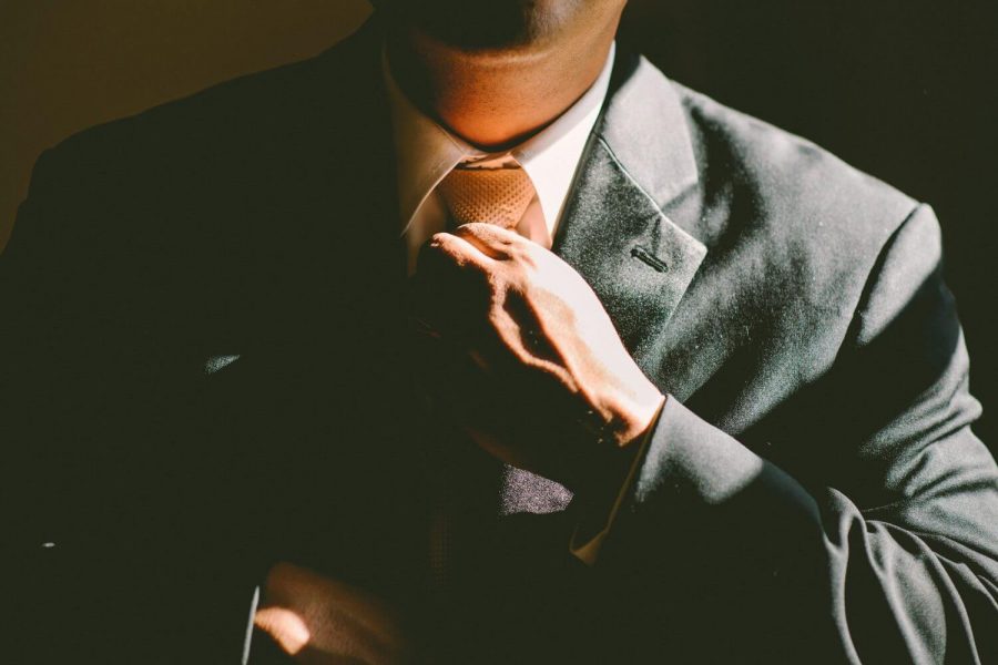 business man fixing his tie